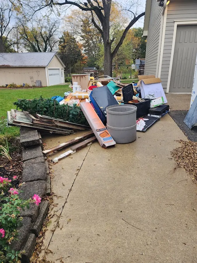 Dumpster being loaded with debris for Estate Cleanout Dumpster Rental in Sangaree
